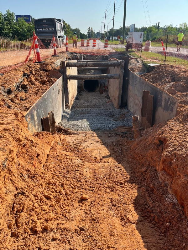 A section of ground dug up to expose the forcemain.