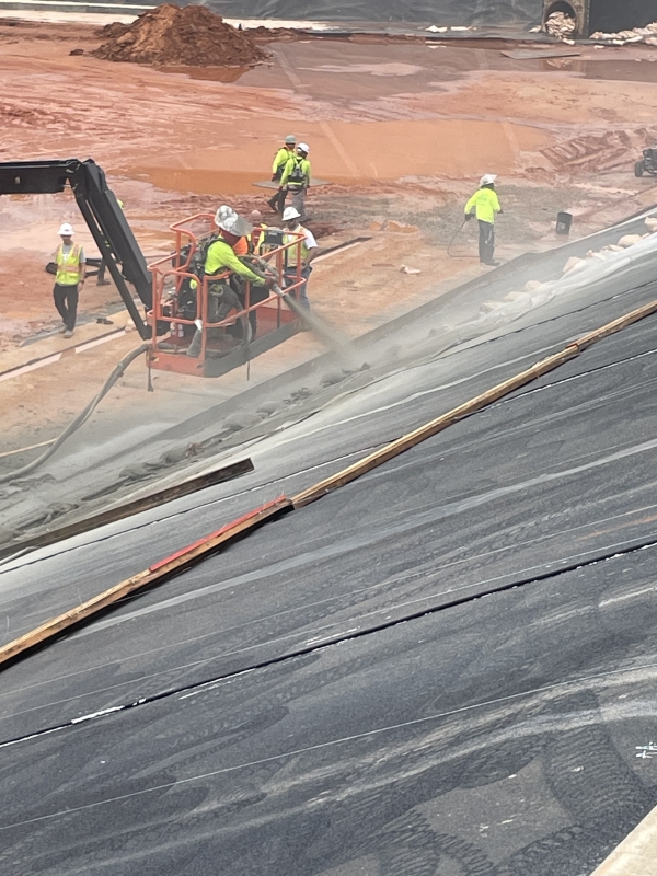 Contractors applying shotcrete to new 50MG reservoir liner.